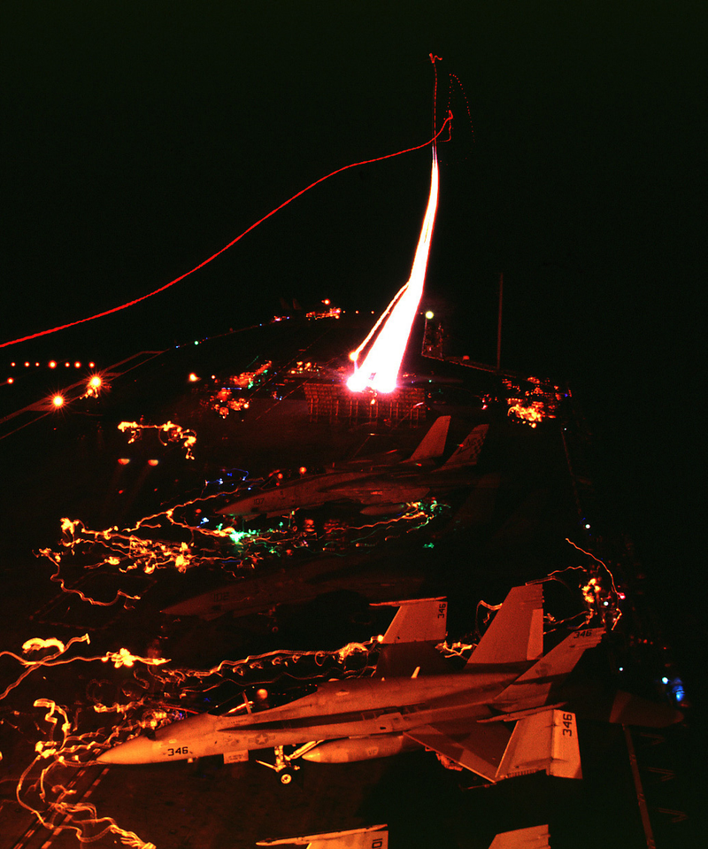 To,cat on left tries to catch the light streaks of the fighter that just took off to its left.